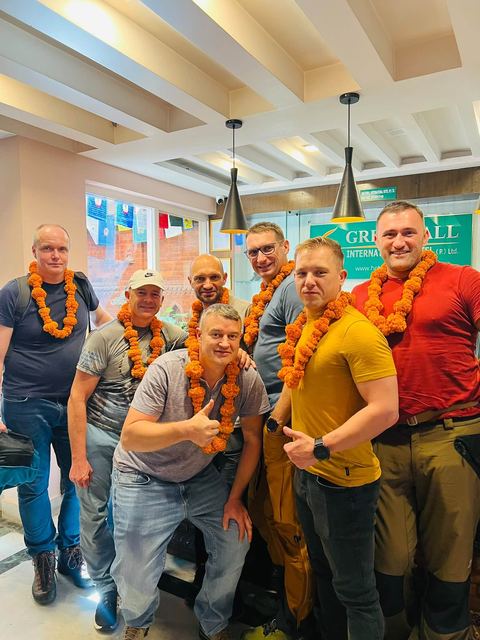 A group of friends with marigold garlands in the lobby